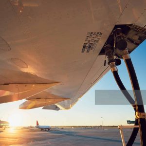 Amazing sunset at the airport. Refueling of the airplane before flight.